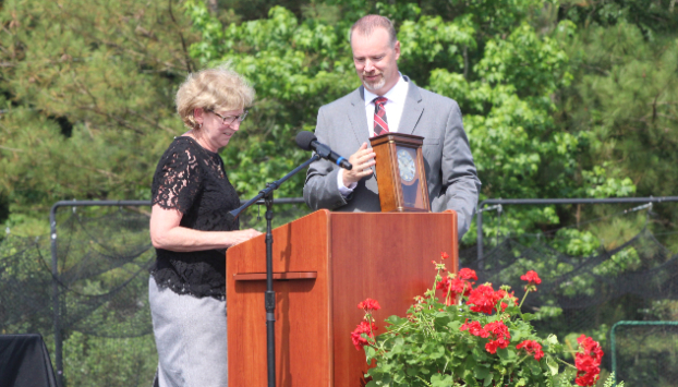 Gray Stone Chief Administrative Officer Helen Nance presents Robert Stock with a clock in honor of his contributions to Gray Stone Day School.