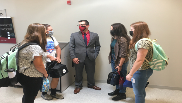 High school leader Jeff Walter meets with high school students as they change classes