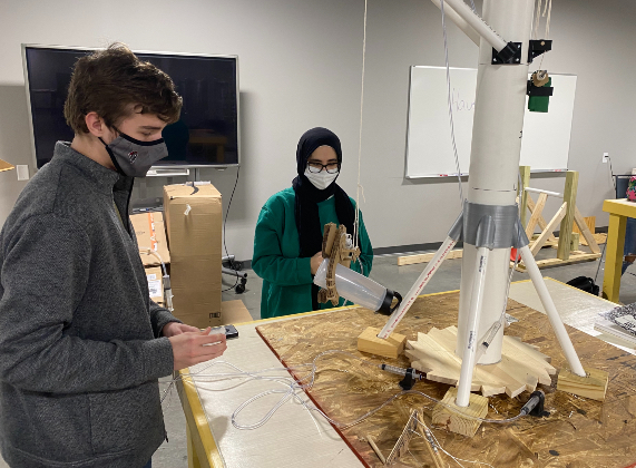 Gray Stone juniors Sean Devlin and Sama Hawari work on a robotic crane that can lift a two-pound object.